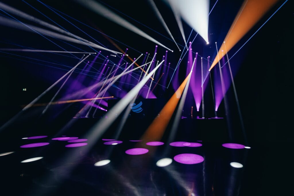 Lighting focus shown in an event venue with beaming spot lights in a multitude of directions and colors